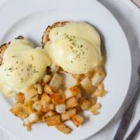 Eggs Benedict · Canadian bacon, two poached eggs and hollandaise sauce on an english muffin. Served with hom...