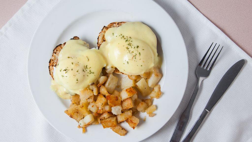Eggs Benedict · Canadian bacon, two poached eggs and hollandaise sauce on an english muffin. Served with home fries.