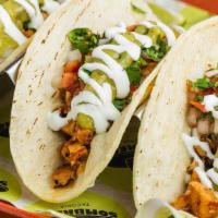 Chorizo Taco Trio · CRISPY CHORIZO, PACKED WITH FLAVOR! SPICED WITH A TANG & HINT OF SMOKE - Three Tacos, on cor...