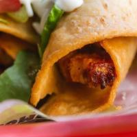 Chicken Taquitos · Two Pieces of our signature Sombrero Chicken Rolled tacos topped with Cotija Cheese, Pico, L...