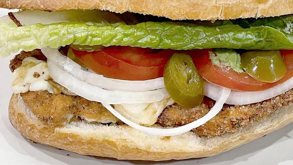 Chicken Milanesa Torta · Mexican Style Sandwich With Chicken Milanesa, Pan Toasted Telera Roll, Refried Beans, Avocado Slices, Jalapeños, Lettuce, Tomatoes, Mozzarella Cheese & Mayo.