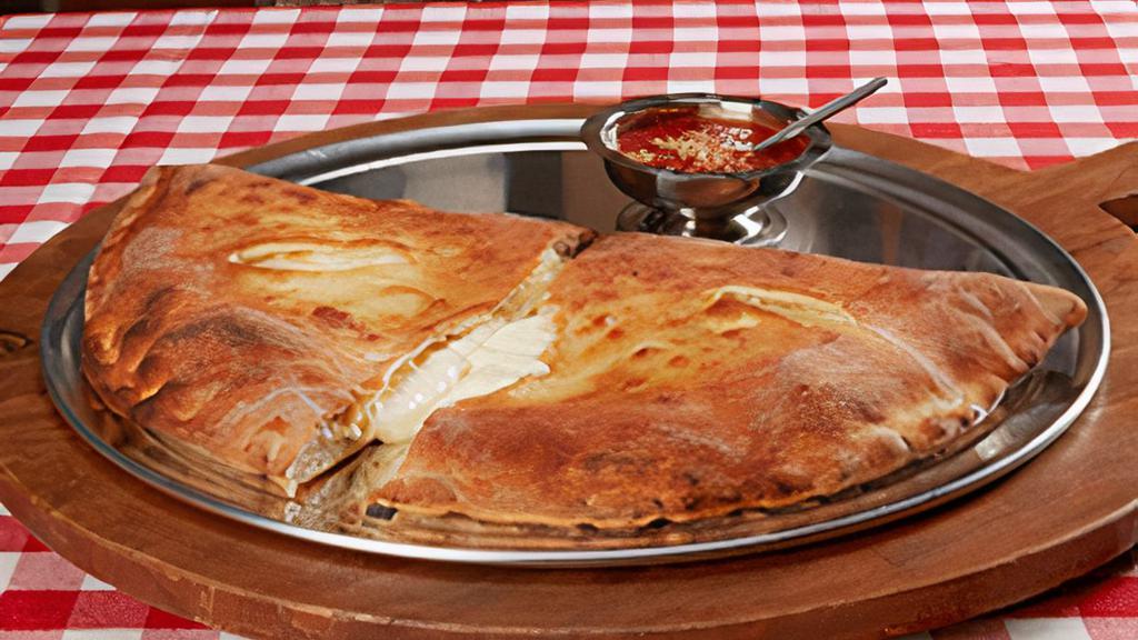 Calzone · Hand tossed dough stuffed with ricotta and mozzarella. Add toppings inside to create your own favorite!