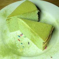 Matcha Mille Crepe Cake · Thin layers of green tea crepes with fresh whipped cream in between.