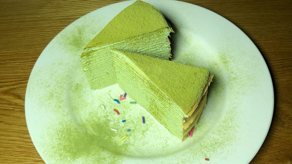 Matcha Mille Crepe Cake · Thin layers of green tea crepes with fresh whipped cream in between.