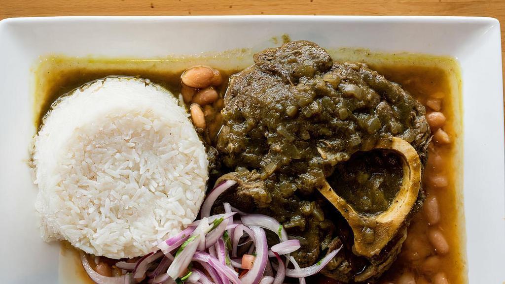 Seco Combinado · Beef stew in cilantro sauce served with rice, beans, and salsa criolla.