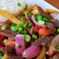 Lomo Saltado Carne O Pollo · Tender beef or chicken sauteed with onions, tomatoes, and soy sauce over French fries. Serve...