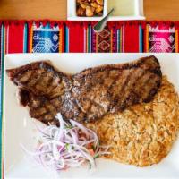 Tacu-Tacu Con Bistec · Rice and beans mixed together served with steak and salsa criolla.