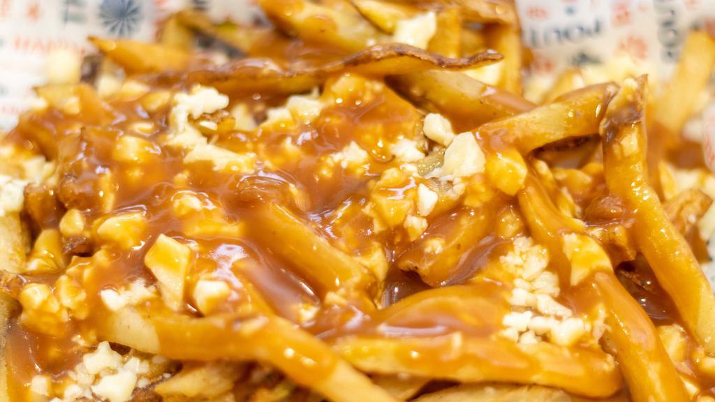 Classique Poutine · Our beef and ale gravy or our savory veggie gravy, and local cheese curds.