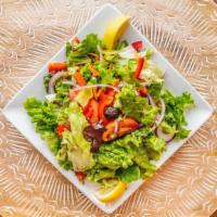 Rumi Salad · Romaine, tomatoes, onions, carrots, parsley, and bell peppers, with lemon vinaigrette.