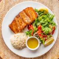 Grilled Salmon · served with rice and Rumi salad. Chunks of salmon grilled.