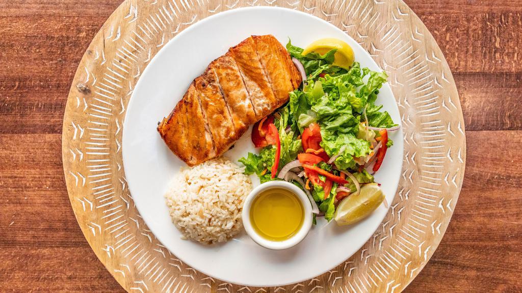 Grilled Salmon · served with rice and Rumi salad. Chunks of salmon grilled.