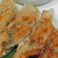 Gyoza · Homemade pan-fried pork dumplings, spicy sesame soy sauce.