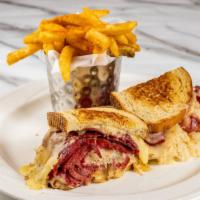 The Carnegie Reuben · Warm Corned Beef, Piled High with Sauerkraut, and Melted Swiss Cheese on Grilled Rye Bread