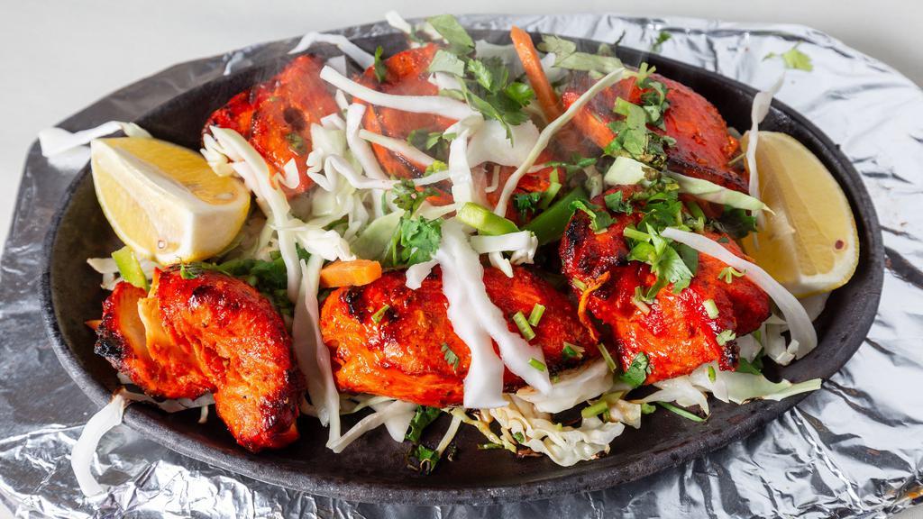 Chicken Tikka · Boneless pieces of chicken marinated with flavored spices and roasted in tandoori oven.