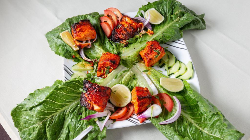 Macchli Fish Tandoori · Juicy pieces of best quality fish marinated in herbs and spices, then broiled over charcoal in tandoori oven, served with rice and salad.