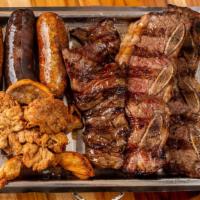 Parrillada · Mixed grill meats: short ribs, skirt steak, sausage, black sausage and sweetbread. For two p...