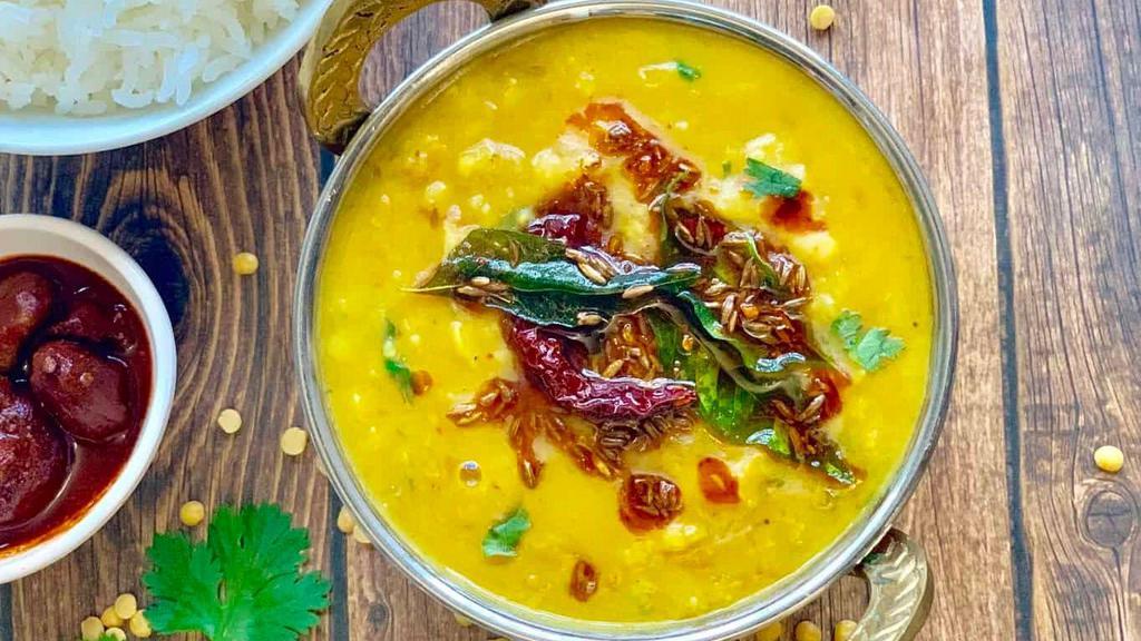 Daal Bright Lights · Yellow lentils, cooked to perfection over a slow flame and tempered with 'ghee' and spices, served with a side of our aromatic basmati rice