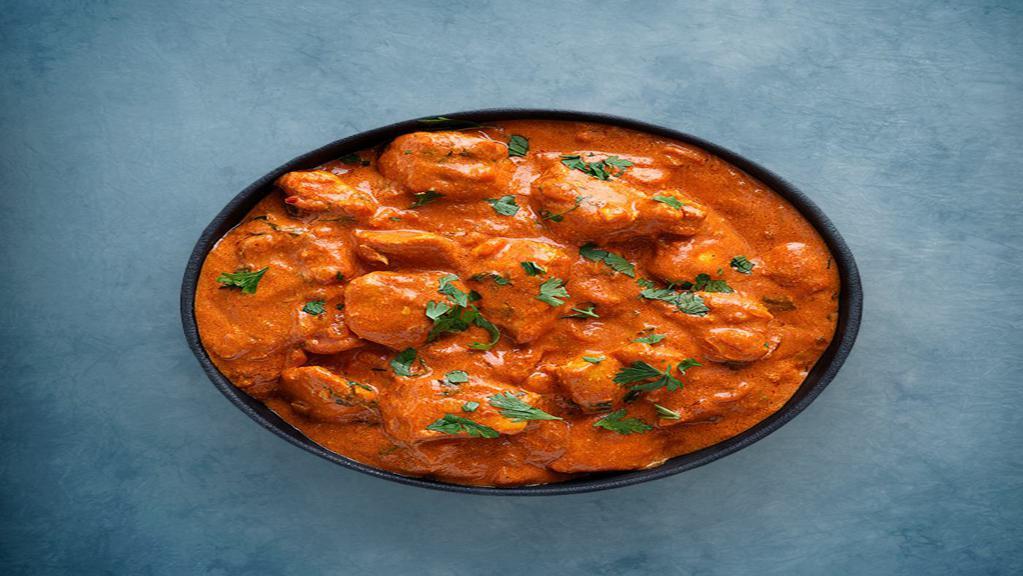 Butter Chicken Peshawari · Tender chunks of char grilled tandoori chicken in a  creamy and deliciously smooth butter, tomato and cream based gravy , spiced with ginger, garlic and aromatic whole spices, served with a side of our aromatic basmati rice