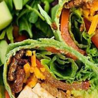 The Cattle Ranch Wrap · Spiced seitan chipotle sausage, sauteed veggies, black beans, brown rice and salsa on side.