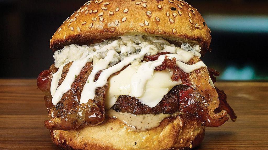 Black & Blue Burger* · Peppered bacon, blue cheese crumbles, melted white American cheese, blue cheese sauce and garlic-lime crema.
