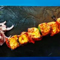 Tandoori Paneer Tikka (Sizzler) · Chunks of paneer, pepper, onions marinated in spices and grilled in a Clay Oven on a sizzlin...