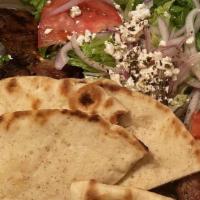 Pork Souvlaki Platter · Tender chunks of pork meat served with Greek fries, salad, tzatziki, and pita bread.