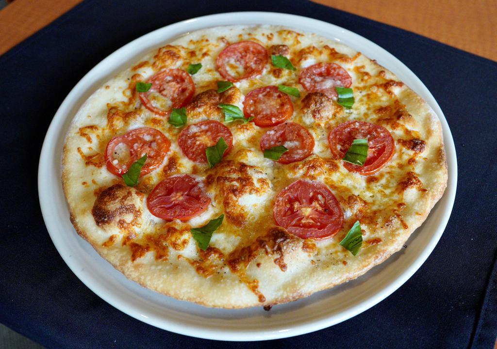 Margherita Pizza · 850 cals. roma tomatoes, garlic oil, basil, mozzarella,
parmesan and aged provolone cheese