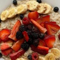 Oatmeal Porridge · Steel cut oats and rolled oats, cinnamon and maple syrup cooked in almond milk and topped wi...