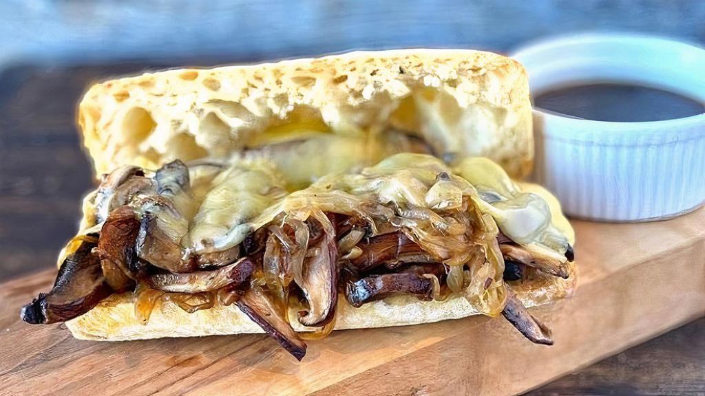 Mushroom French Dip · Portobello and shiitake mushrooms, Swiss cheese and caramelized onions on a French baguette. Served with mushroom au jus for dipping
