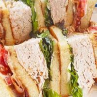 Turkey Club · Turkey, romaine, bacon, tomato and Hellmann’s mayonnaise on white toast