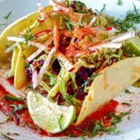 Fish Tacos · Catch of the day, avocado crema, red cabbage-pickled jalapeño slaw, radish, lime, corn torti...