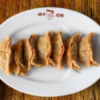 Gyoza · Pan fried dumplings made with pork and vegetables.