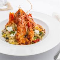 Garides Kritharoto · Prawns, orzo, grilled vegetables, fresh herbs, pine nuts and goat cheese.