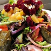 Stuffed Grape Leaves Salad · Mixed baby greens, tomatoes, cucumbers, onions and beets, with pomegranate vinaigrette.