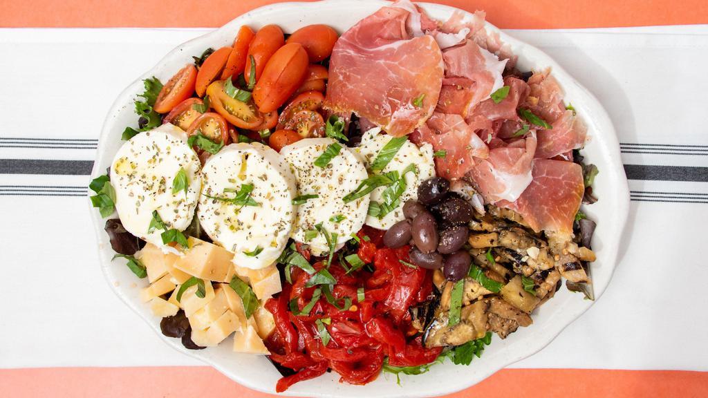 Italian Antipasto · Prosciutto di Parma, fresh mozzarella, imported cheeses, roasted peppers, grilled eggplant over mixed greens & our homemade sun-dried tomato dressing.