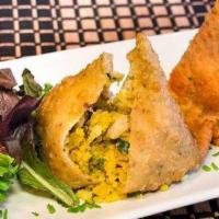 Chicken Samosa · Seasoned chicken mixed with green peas and spices, wrapped in a crispy pastry.