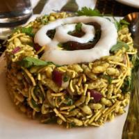 Bhel Poori · Puffed rice, onion, and tomato tossed with fresh herbs, tamarind and cilantro chutneys.