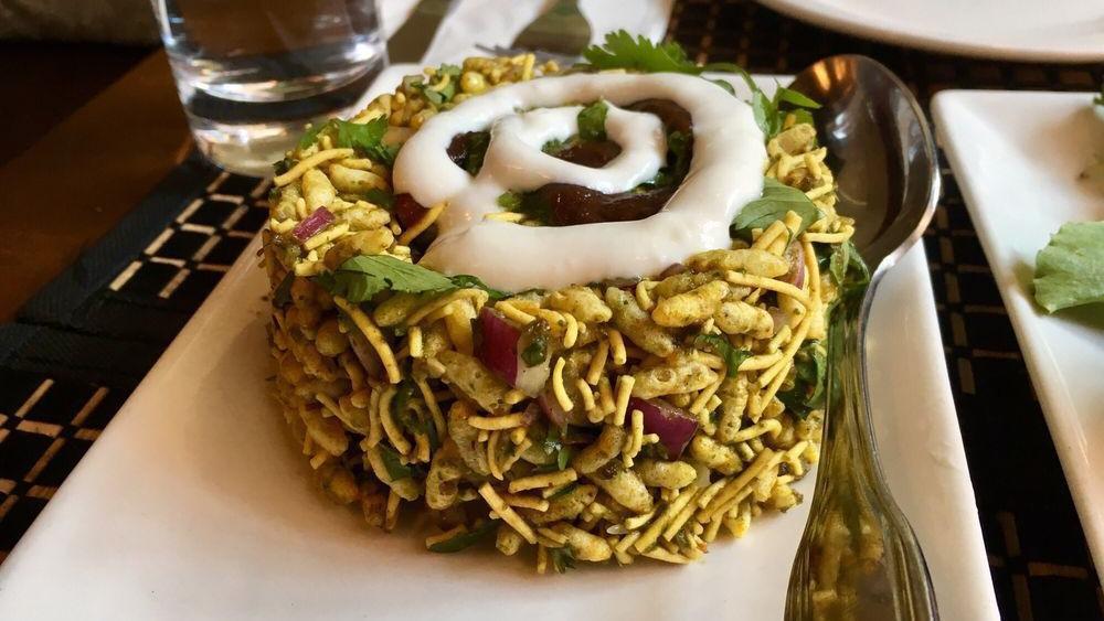 Bhel Poori · Puffed rice, onion, and tomato tossed with fresh herbs, tamarind and cilantro chutneys.