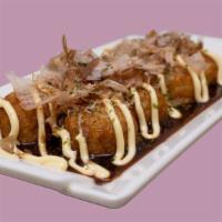Fried Takoyaki · 8pcs - Fried Octopus dough ball, drizzled with sweet mayo and tangy sauce, topped with bonit...