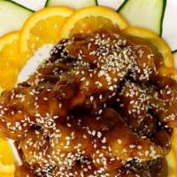 Sesame Chicken · Dark chicken meat blended with sauce and garnished with sesame seeds with white rice.