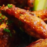 Wings · Cooked wing of a chicken coated in sauce or seasoning.