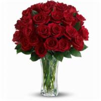 Love And Devotion - Long Stemmed Red Roses · The spectacular bouquet features two dozen red roses accented with salal.