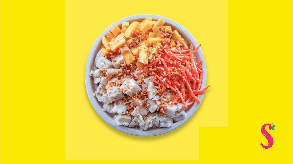 Mango Chicken Poké Bowl · Chicken, Mango, Carrots, Lime Cilantro Dressing topped with fried onions and fried garlic.