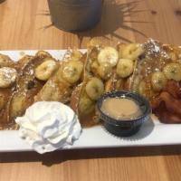 Bananas Foster French Toast · Thick sliced french toast topped with caramelized bananas, whipped cream and served with hom...
