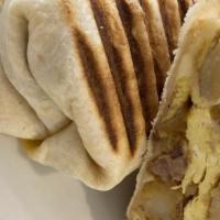 Breakfast Burrito · Two eggs, choice of potato, meat and cheese grilled and served in a white or wheat wrap.