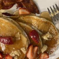 Classic Pancakes · Fluffy pancakes topped with fresh fruit and served with homemade maple butter and choice of ...