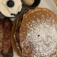 Blueberry Pancakes · Served with lemon infused ricotta cheese, maple butter and fresh blueberries with your choic...