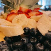 Pineapple Bowl · Half of a Pineapple, fresh bananas, strawberries, and blueberries drizzled with honey