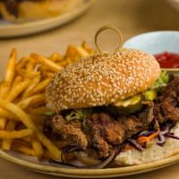 Fried Chicken Burger · buttermilk fried chicken, summer slaw, spicy pickle, spicy aioli, romaine on a sesame potato...