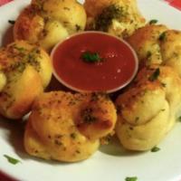Garlic Knots With Tomato Sauce · Bread, topped with garlic, herb seasoning, baked to perfection.
